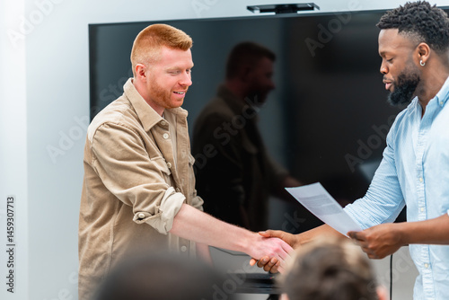 Obraz na płótnie Businessmen shaking hands after signing contract in meeting room w salonie