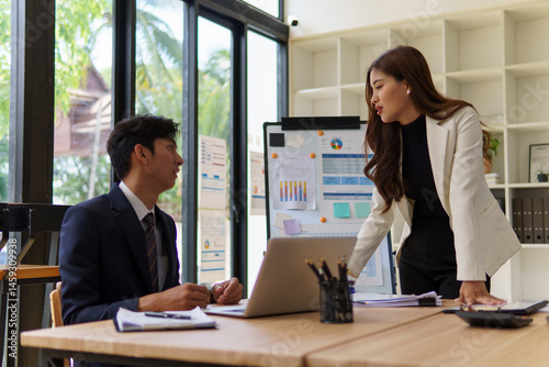 Businesswoman explaining a concept to her colleague during a meeting.