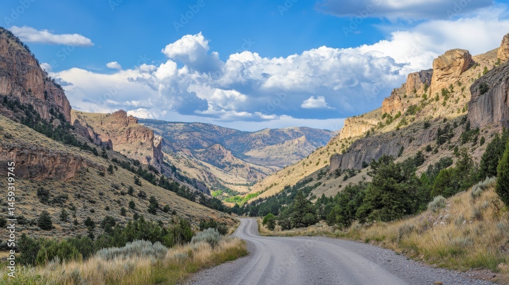Fototapeta premium Isolated American road heading through a high-altitude valley surrounded by mountains and sky