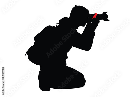 Silhouette of photographer kneeling taking photo