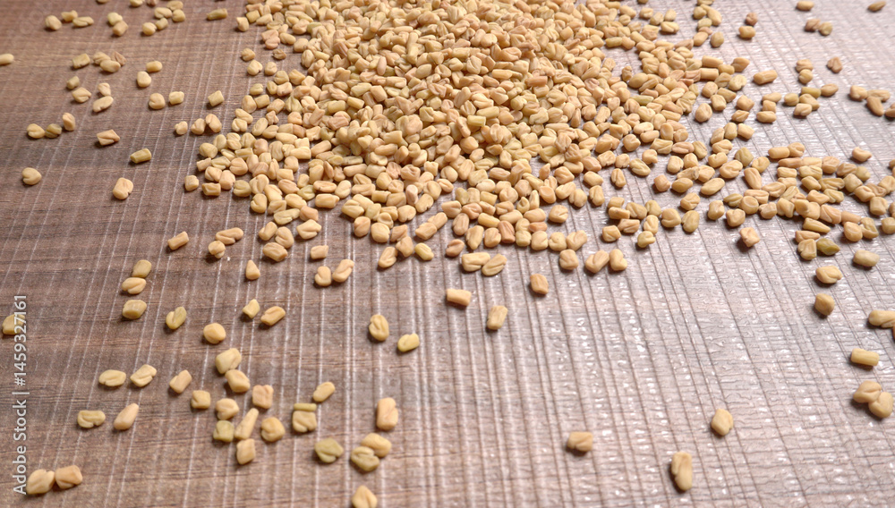 Fototapeta premium Methi or fenugreek seeds with methi leaves.Methi seeds is good for health.