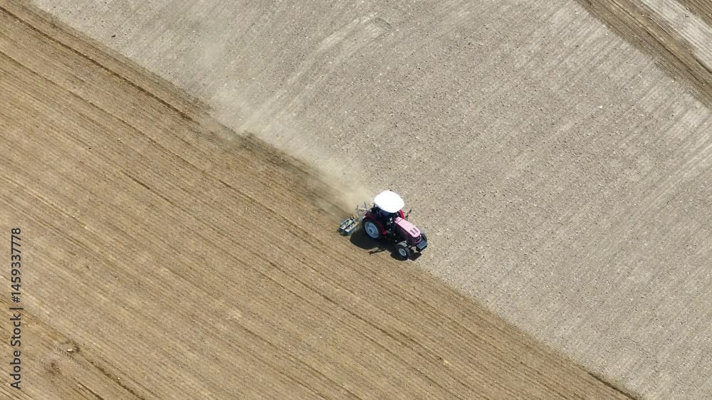 Tractor plowing the field - Red tractor plowing the field, 4k aerial shot with drone Tractor plowing the field - Red tractor plowing the field, 4k aerial shot with drone