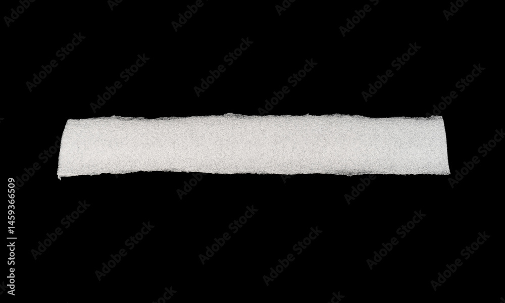 Obraz premium A long, white, textured roll against a black background.