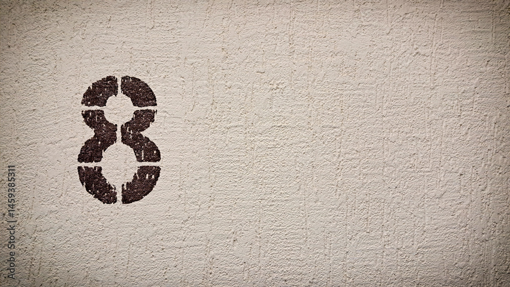 Stencil number 8 on rough wall with copy space