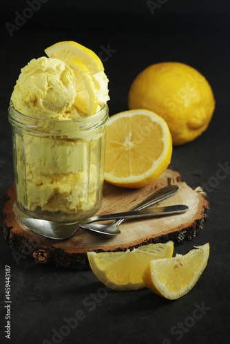 Lemon ice cream scoops in glass jar	