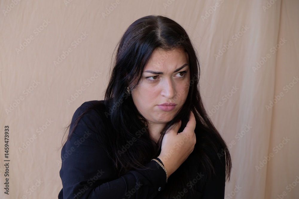 Obraz premium A white woman with dark hair is very upset and will soon cry with resentment