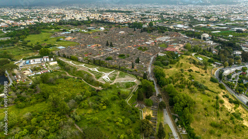 Obraz na płótnie Aerial view of the ruins and remains in the archaeological park of Pompeii, located in the province of Naples, Campania, Italy. It was an ancient Roman town. In background there is the modern city. w salonie