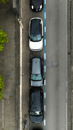Obraz na płótnie Aerial zenithal view on a narrow street with parked cars. This urban road is located in Italy. w salonie