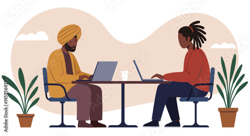Person in a turban working on a laptop at a coffee table next to another person with dreadlocks. Co-working space concept
