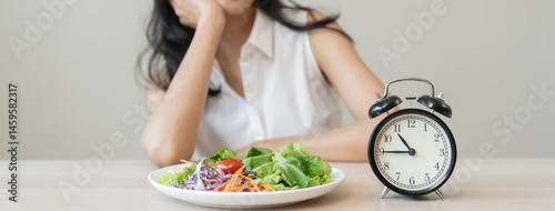 Intermittent Fasting eat concept, Woman looking at meal waiting time to eat during intermittent fasting session