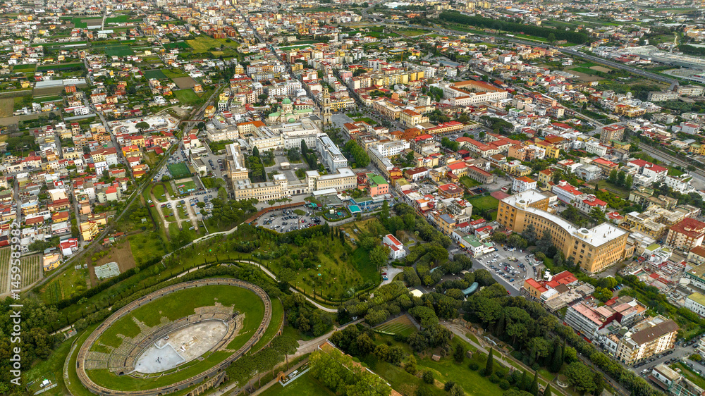 Aerial view of the modern city od Pompei located in the province of Naples, Campania, Italy. In foreground there is the remains of the Pompeii amphitheater.