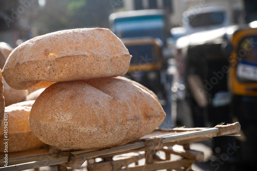 Freshly oven baked traditional Baladi flat bread, for sale in Cairo, similar to pitta bread is a staple of Egyptian cuisine is cooked and sold all over Egypt