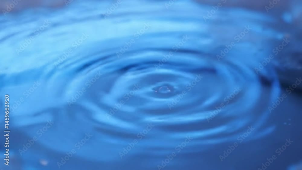 Captivating Liquid Dance: Slow Motion Water Drop Creating Ripples in Serene Blue Hues Captivating Liquid Dance: Slow Motion Water Drop Creating Ripples in Serene Blue Hues