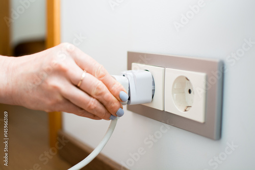Universal travel adapter in a socket close-up