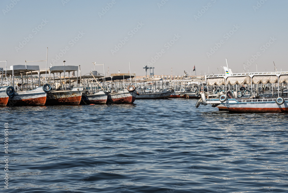 Obraz premium Many docked tour boats and ferries by the Old Aswan dam used to transport tourists to Philae Temple