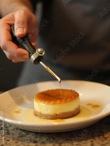 A chef using a torch to caramelize the top of a dessert, creating a caramelized finish. 
