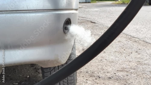 A gas leak occurred due to faulty gas equipment. Car at a gas station is filled with LPG propane or methane CNG gas. 