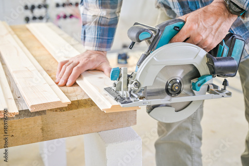 A skilled craftsman operates a circular saw on a wooden plank, showcasing precision and craftsmanship in a well-lit workshop environment, highlighting woodworking techniques