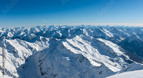 Panoramic View of Snow Covered Mountain Range Under a Clear Blue Sky