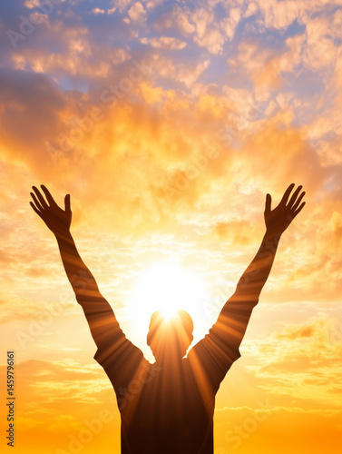 Silhouette of hands raised in worship against vibrant sunset, symbolizing hope and gratitude in moment of reflection