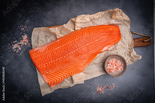 Obraz na płótnie Salmon. Fresh raw salmon fish fillet with cooking ingredients on dark background, top view. High quality photo w salonie