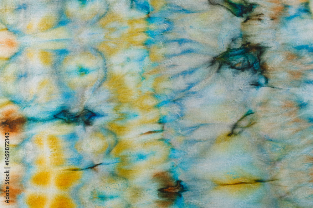 abstract pattern on silk fabric texture in blue, yellow, green colors
