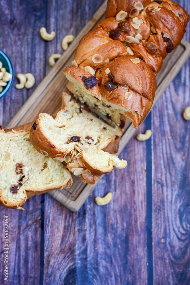 Fototapeta premium Brioche bread. Home made easter butter covered with sugar on wooden background.