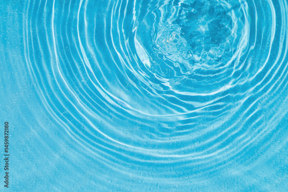 drops on water with circles on a blue background