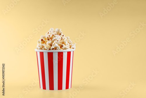 Obraz na płótnie Classic red striped popcorn cardboard cup on Yellow background w salonie