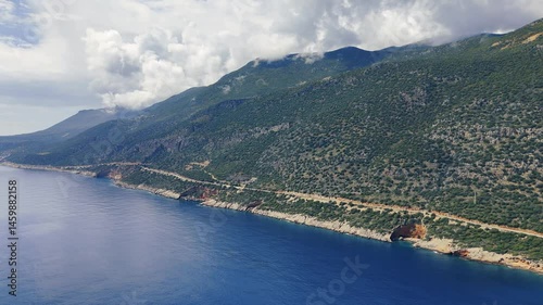 Crystal clear turquoise water gently caressing the shores of a secluded cove, surrounded by lush green hills under a bright sky, creating a peaceful and idyllic mediterranean scenery