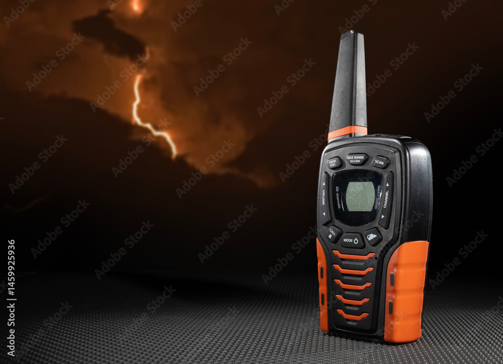 UHF walkie-talkie on a table with rubber mat and lightning striking behind