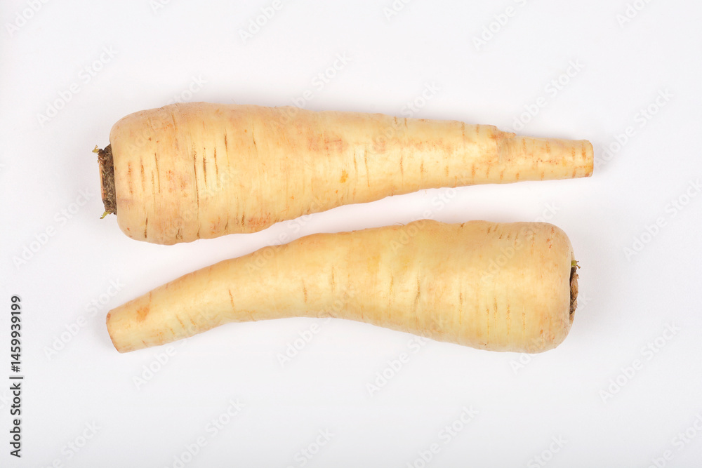 Two beige parsnips lie horizontally parallel on a plain white surface