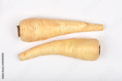 Obraz na płótnie Two beige parsnips lie horizontally parallel on a plain white surface w salonie