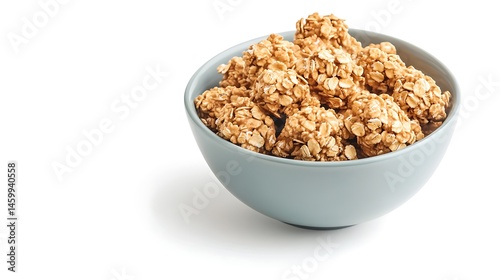 A bowl filled with homemade oatmeal energy balls on a white surface