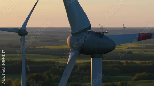 Wind farm at sunrise, wind generators aerial view, windmills generating electricity, drone shot, golden hour, green renewable energy, wind turbine