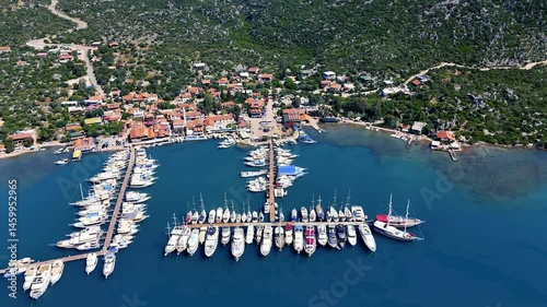 Yachts and sailboats moored in Ucagiz marina, offering breathtaking aerial perspective of summer vacations