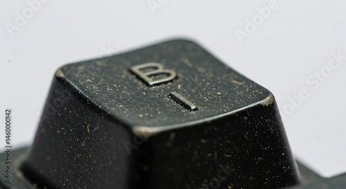 Keyboard keycap with usage wear marks.
