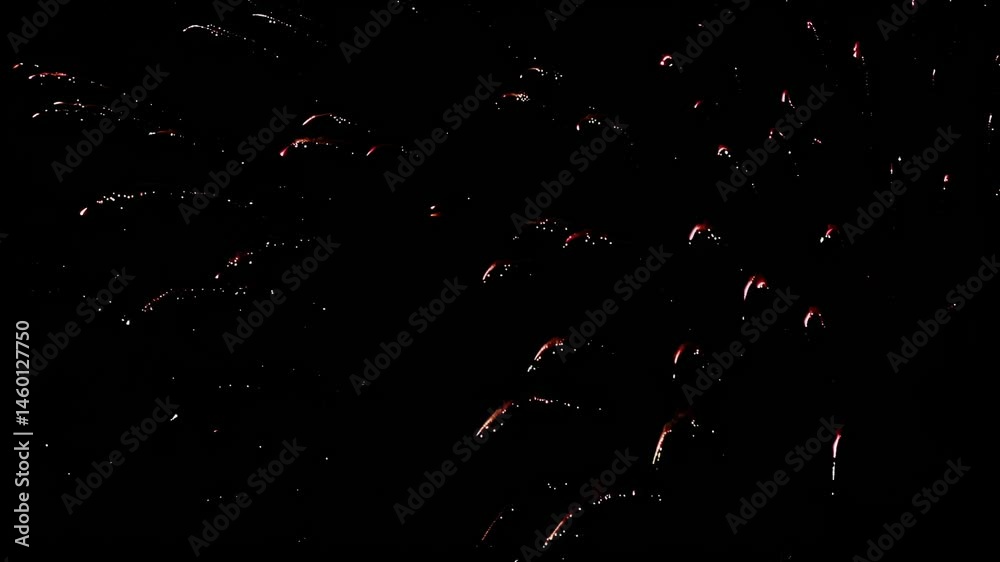Red fireworks stream into the night