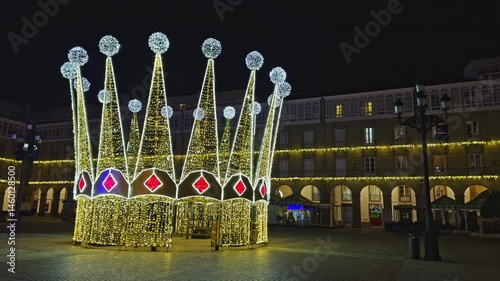Night view of illuminated crown-shaped Christmas decoration in town square