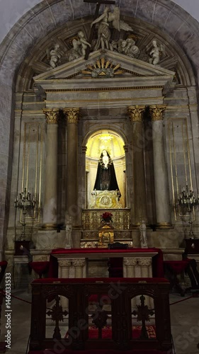 Religious altar with statue of Virgin Mary in black robe