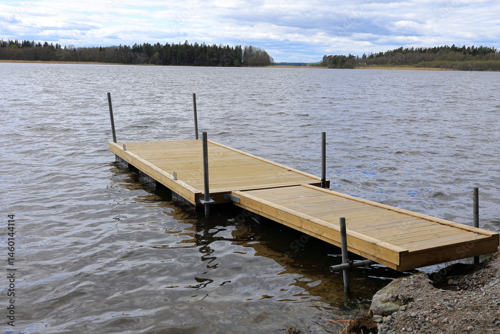 Naklejka premium Wooden bench at Mälaren lake. Stockholm, Sweden. May 2025.