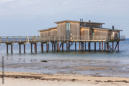 Wooden bathhouse on stilts over the sea in Torekov, Sweden.