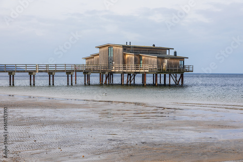 Wooden bathhouse on stilts over the sea in Torekov, Sweden.