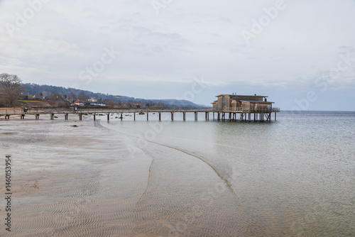 Wooden bathhouse on stilts over the sea in Torekov, Sweden.