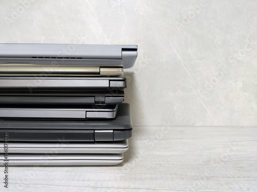 stack of laptops on a gray background, on the table, laptop computer, tablet, business, work, remote work, freelance