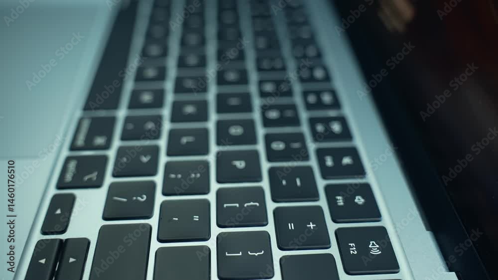 Modern keyboard with a laptop in a clean, tech-savvy workspace. Remote work, productivity, digital life, or technology. Connection between human interaction and computer-driven tasks