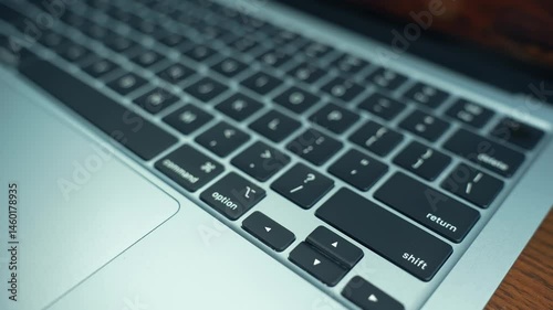 Modern keyboard with a laptop in a clean, tech-savvy workspace. Remote work, productivity, digital life, or technology. Connection between human interaction and computer-driven tasks