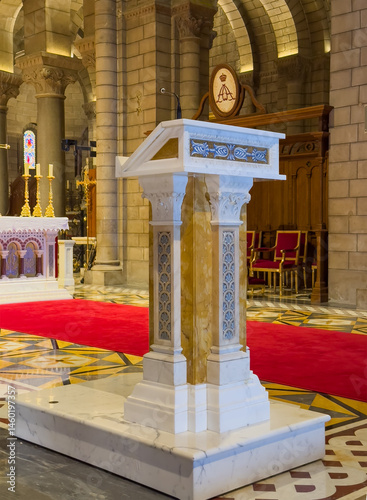 Principality of Monaco, France - July 9, 2024: Cathedral of Our Immaculate Lady. Decorated stone Pulpit in front of main altar. Red carpet photo