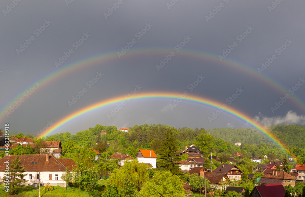A double rainbow over a village