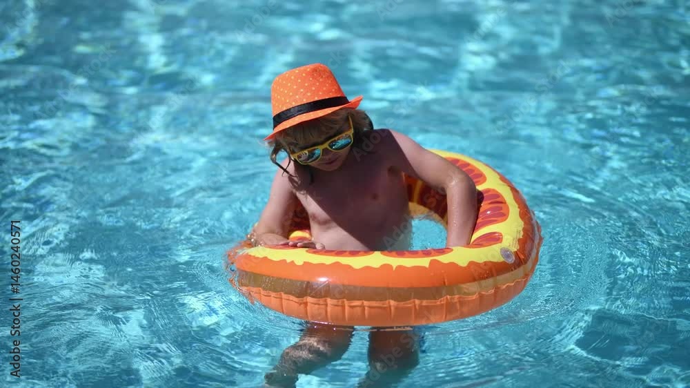 Swimming pool fun with happy kid. Kid splash in pool on summer day ...